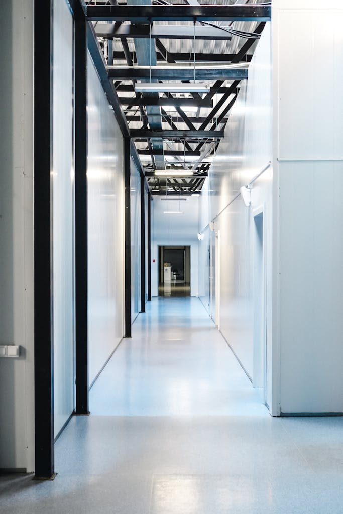 Empty industrial hallway with minimalist design, showcasing clean lines and bright lighting.