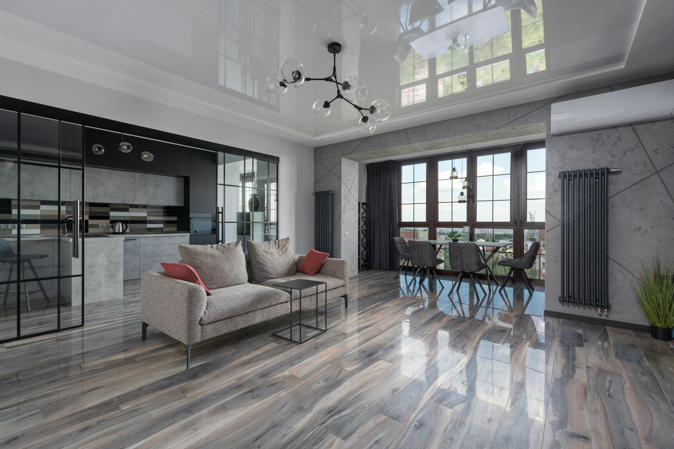 Spacious living room with modern furnishings and large windows offering bright natural light.